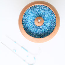 Rotating pot for attaching beads to string