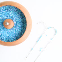 Rotating pot for attaching beads to string