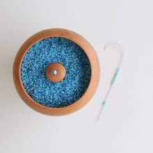Rotating pot for attaching beads to string